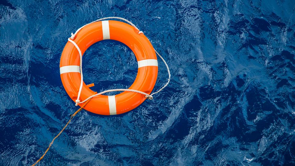 Safety equipment, Life buoy or rescue buoy floating on sea to rescue people from drowning man.